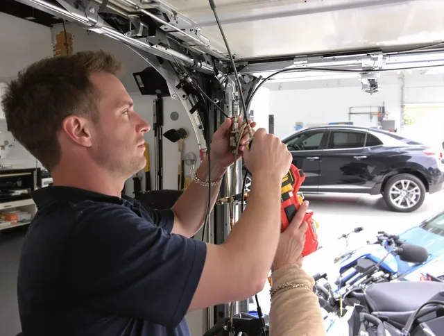 Raynham Garage Door Repair safety certified technician performing cable replacement in Raynham