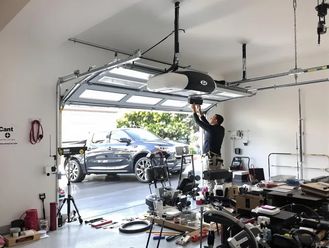 Raynham Garage Door Repair specialist installing smart garage door opener system in Raynham home