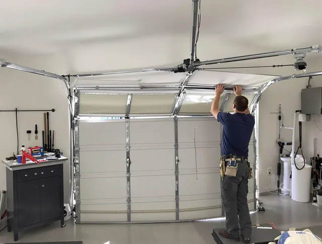 Raynham Garage Door Repair specialist performing precise section replacement on Raynham garage door